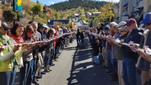 Crowd lining both sides of Park City's Historic Main Street holding shot skis during the Park City Shot Ski